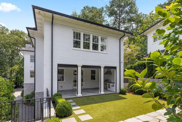 a view of a house with a yard and plants