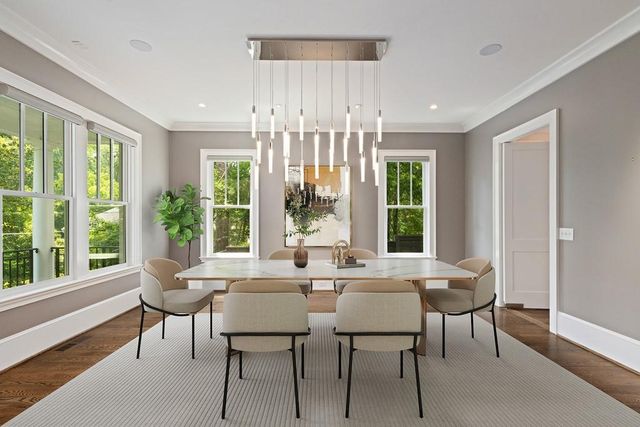 a view of a dining room with furniture large windows and wooden floor