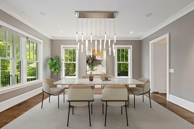 a view of a dining room with furniture large windows and wooden floor