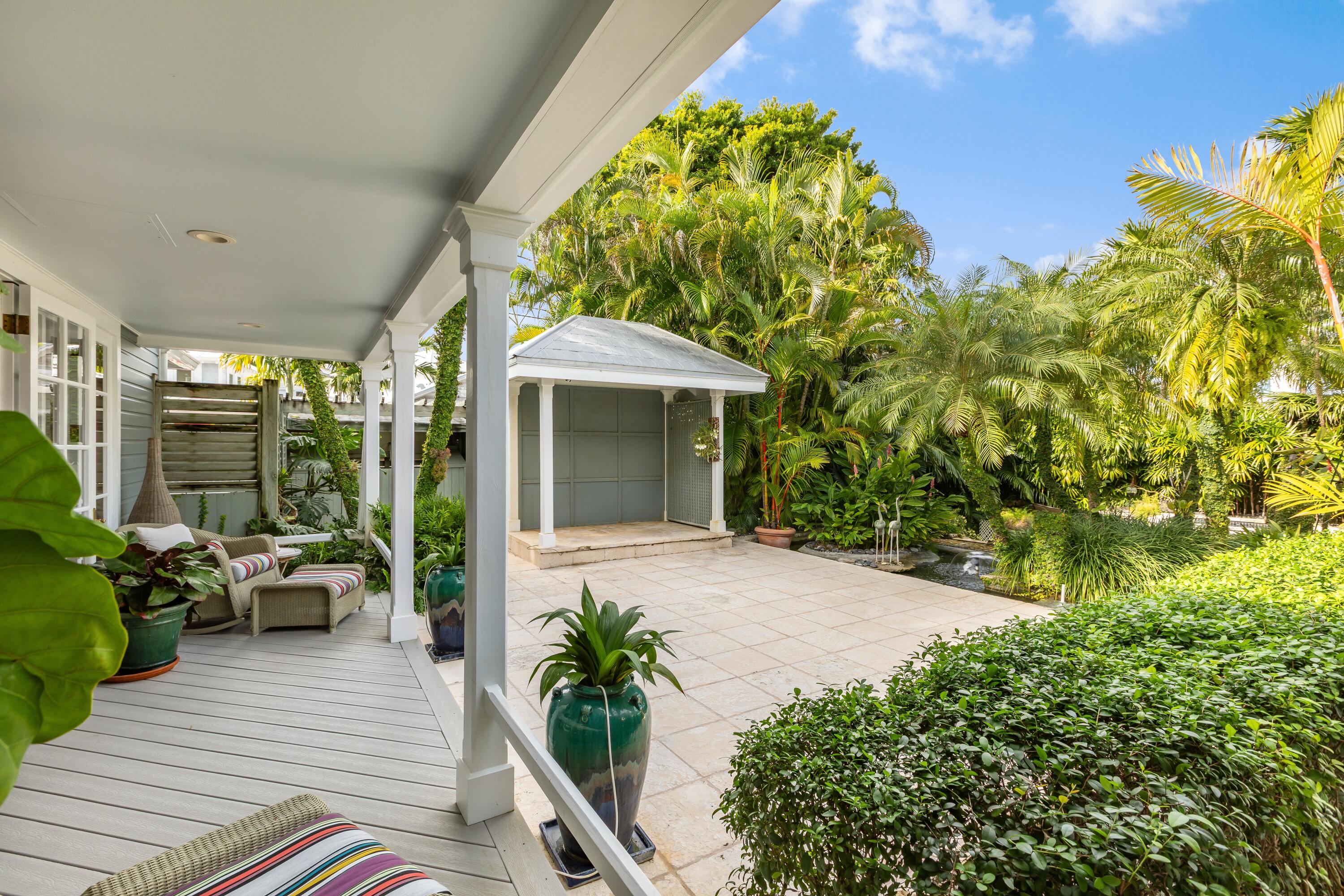 910-914 Watson Street Key West, FL 33040 - Photo 14 of 38 a porch with seating space and yard in back