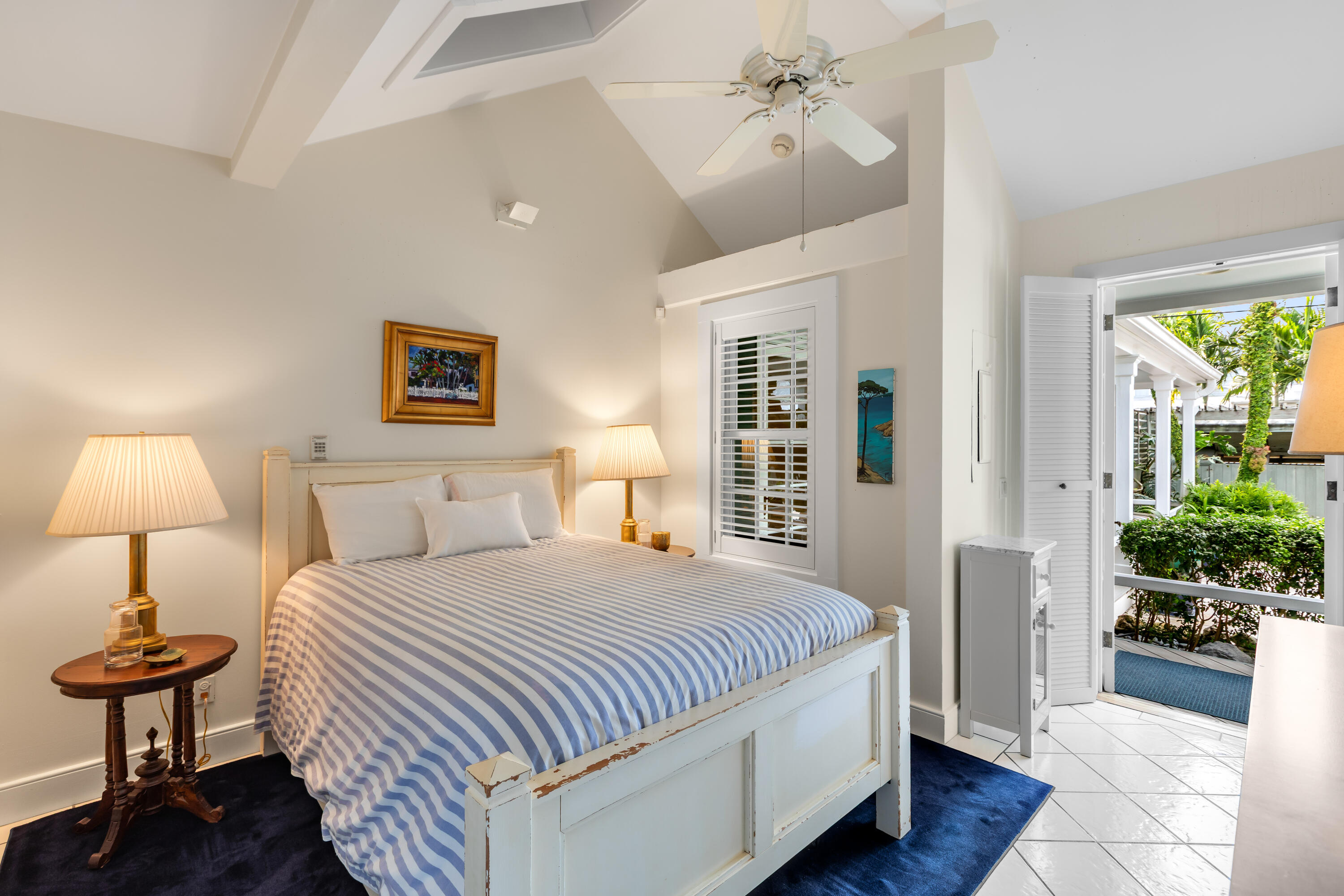 910-914 Watson Street Key West, FL 33040 - Photo 36 of 38 a bedroom with a bed and a chandelier