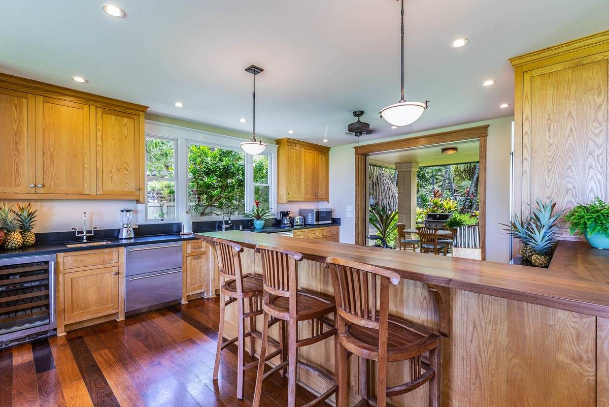 5070 Kukuna Road Kilauea, HI 96754 - Photo 11 of 30 a large kitchen with lots of counter space and windows