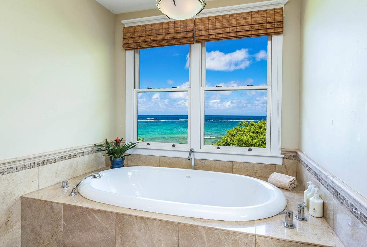 5070 Kukuna Road Kilauea, HI 96754 - Photo 15 of 30 a white bath tub sitting in a bathroom next to a window