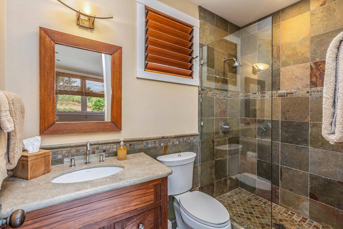 5070 Kukuna Road Kilauea, HI 96754 - Photo 19 of 30 a bathroom with a sink a toilet and shower