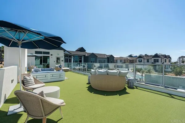 a view of backyard with swimming pool and seating space