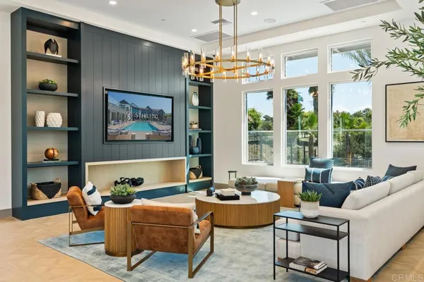 a living room with furniture chandelier and a large window