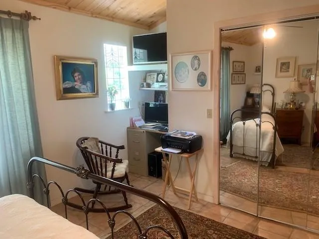 a bed room with a bed and a mirror