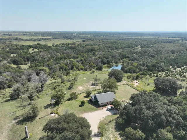 an aerial view of residential houses with outdoor space