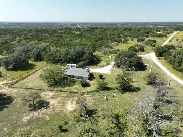 an aerial view of residential houses with city view