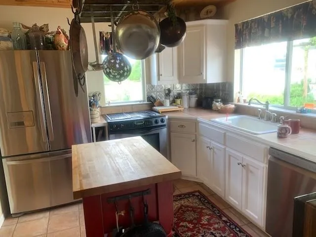 a living room with furniture a flat screen tv and a window