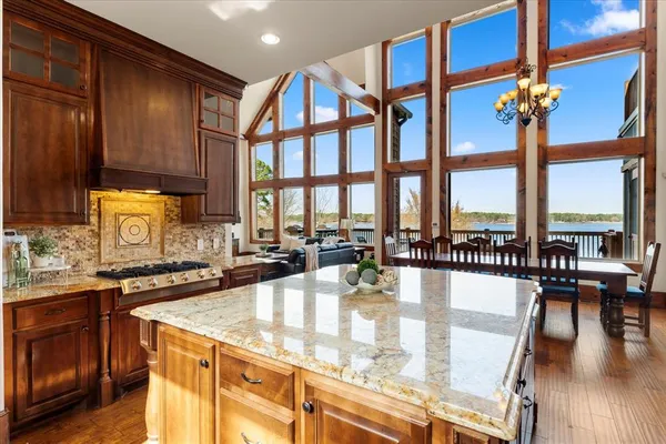 a kitchen with stainless steel appliances granite countertop a stove and cabinets with wooden floor