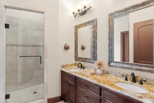 a bathroom with a granite countertop sink mirror and double