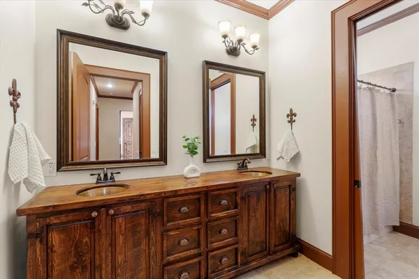 a bathroom with a double vanity sink and a mirror