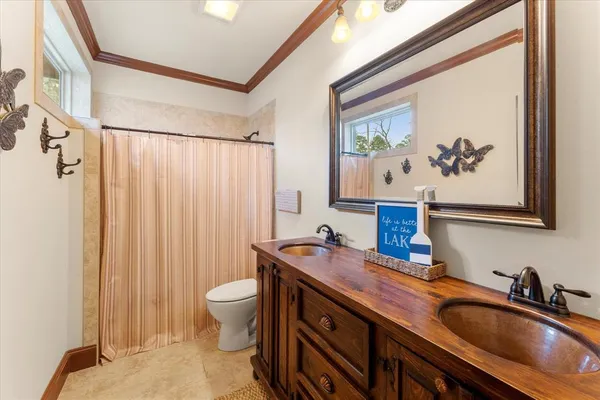 a bathroom with a sink a toilet and a mirror