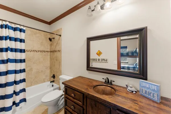 a bathroom with a granite countertop sink mirror toilet and bathtub