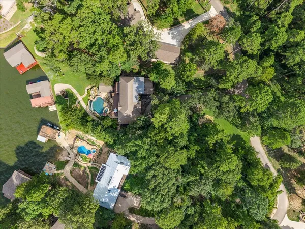 an aerial view of a house with a yard basket ball court and outdoor seating
