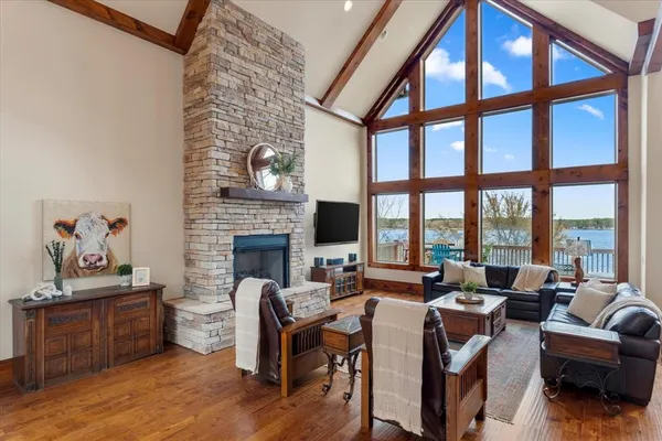 a living room with furniture a fireplace and a floor to ceiling window