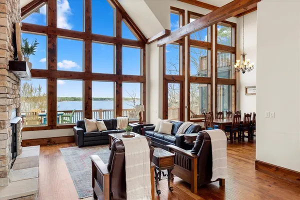 a living room with furniture and floor to ceiling windows