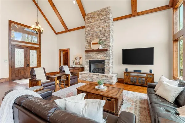 a living room with fireplace furniture and a flat screen tv