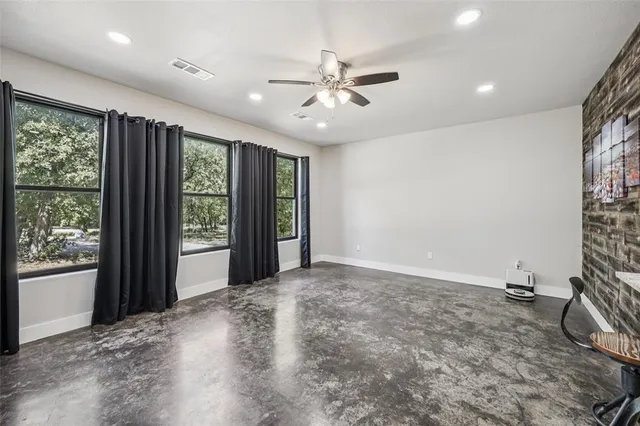 a view of a livingroom with a ceiling fan and window