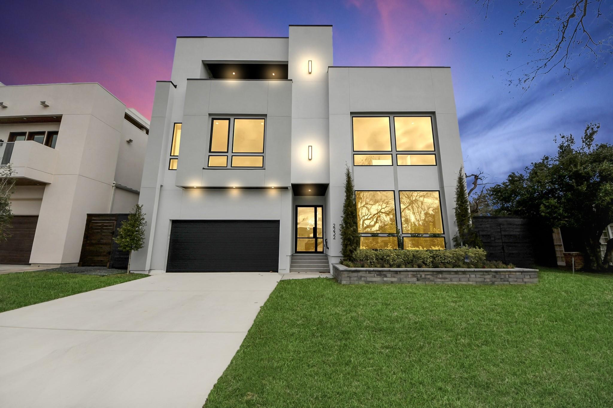 Modern 3-story contemporary home in Southgate featuring clean architectural lines, large windows, and a 4-car attached garage.