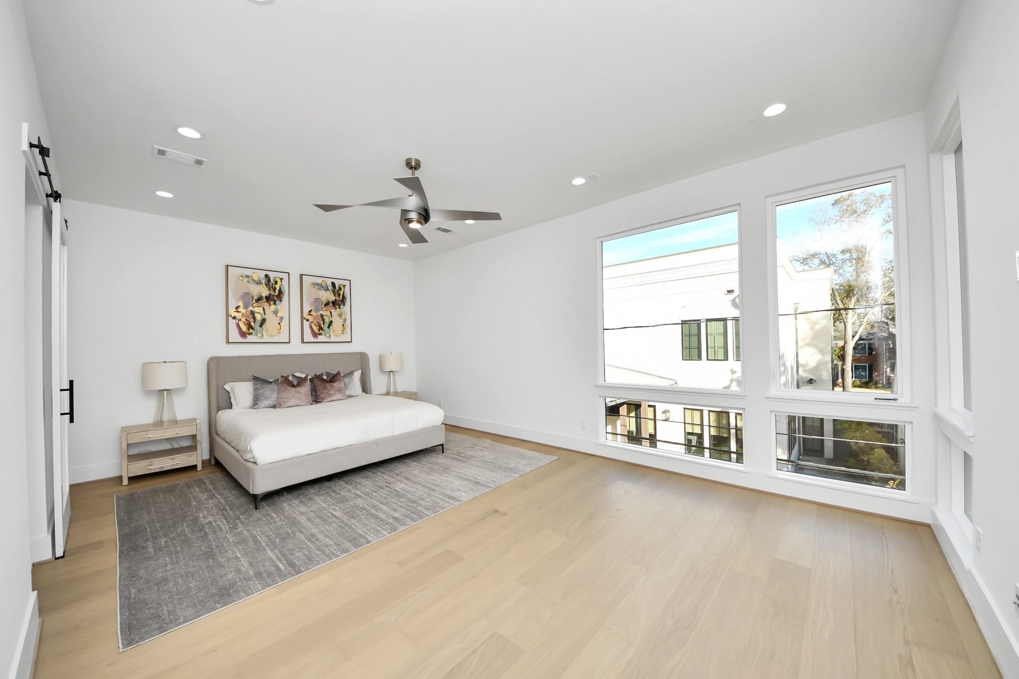 2232 Swift Boulevard Houston, TX 77030 - Photo 21 of 46 Second-floor primary suite with large windows and wood flooring.