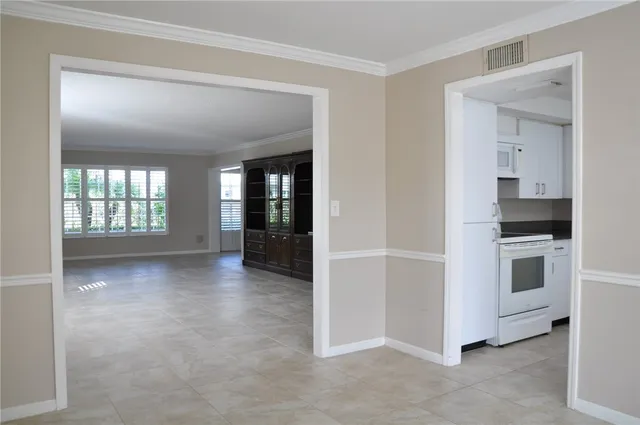 a view of a kitchen with white cabinets and a stove top oven
