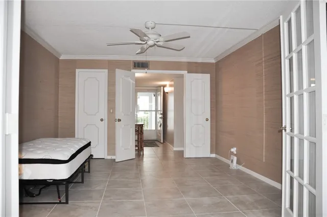 a view of a room that has a large window and closet