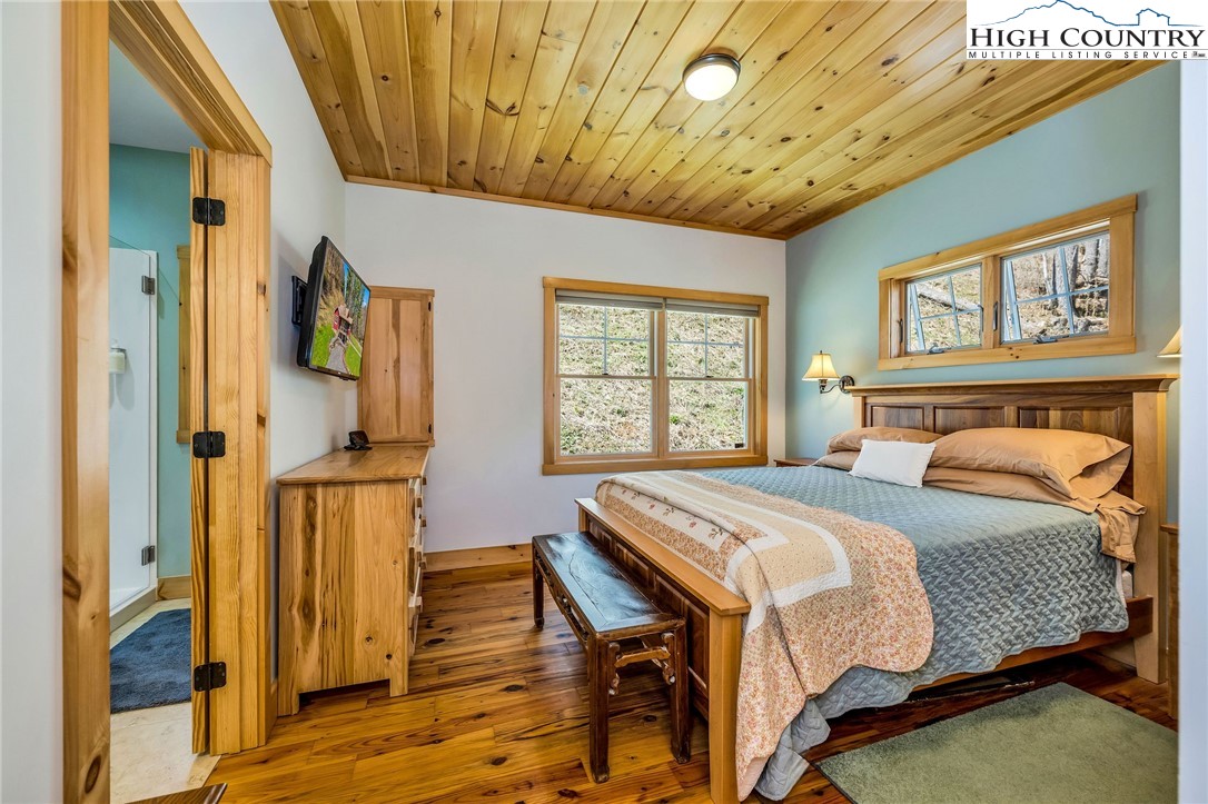 1976 Hartzog Ford Road West Jefferson, NC 28694 - Photo 16 of 50 a bedroom with a bed next to a window