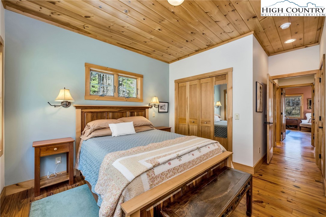 1976 Hartzog Ford Road West Jefferson, NC 28694 - Photo 17 of 50 a bedroom with a bed and wooden floor