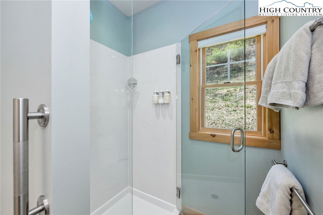 1976 Hartzog Ford Road West Jefferson, NC 28694 - Photo 19 of 50 a view of a bathroom with tub and windows