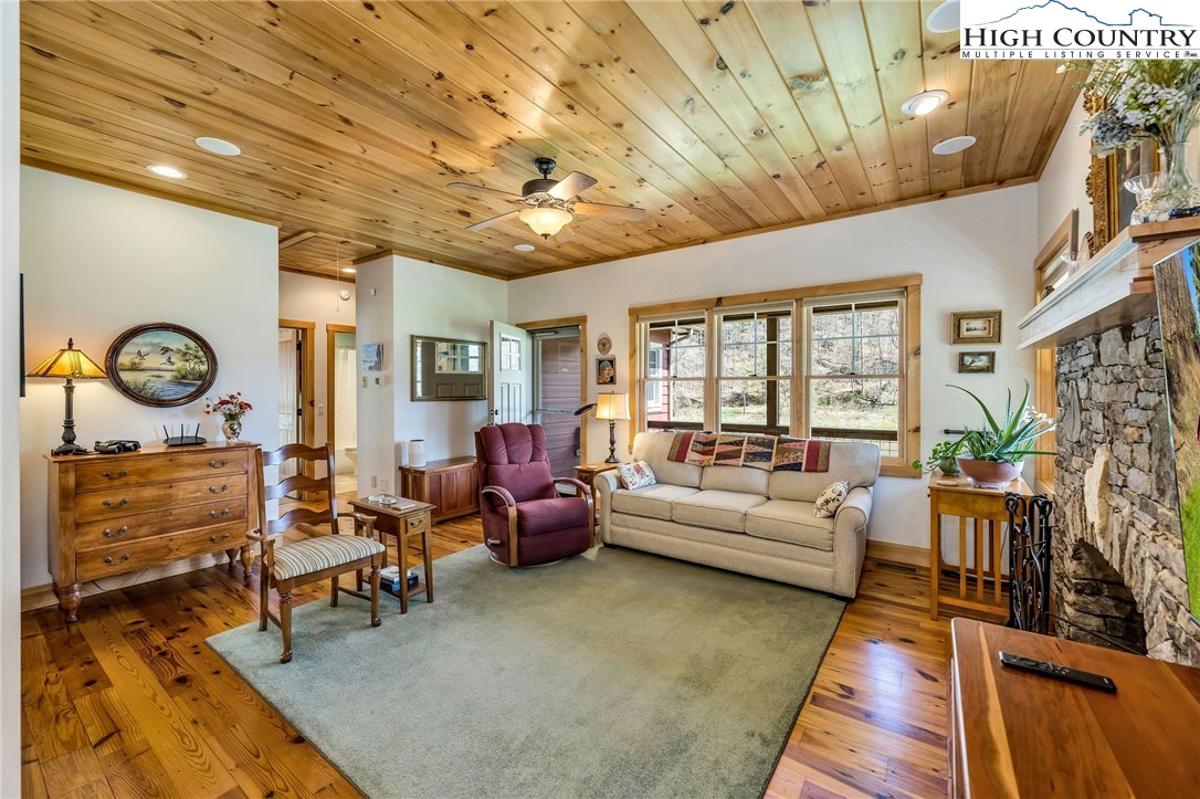 1976 Hartzog Ford Road West Jefferson, NC 28694 - Photo 20 of 50 a living room with fireplace furniture and a rug