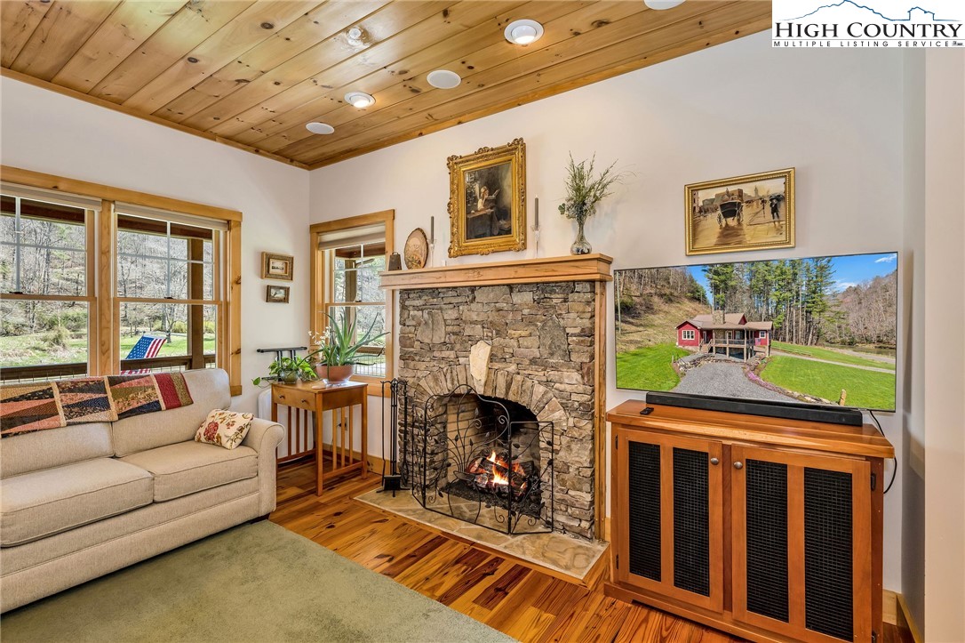 1976 Hartzog Ford Road West Jefferson, NC 28694 - Photo 24 of 50 a living room with fireplace furniture and a fireplace