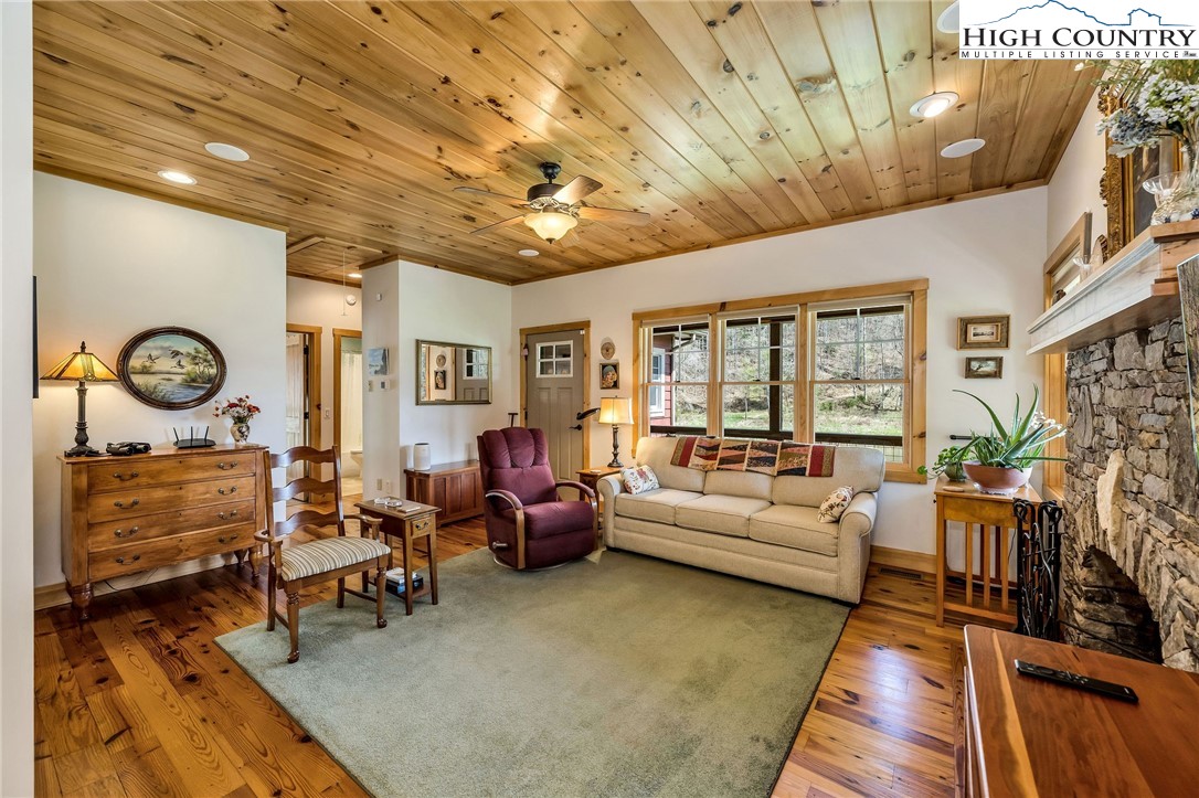 1976 Hartzog Ford Road West Jefferson, NC 28694 - Photo 25 of 50 a living room with furniture a fireplace and a table