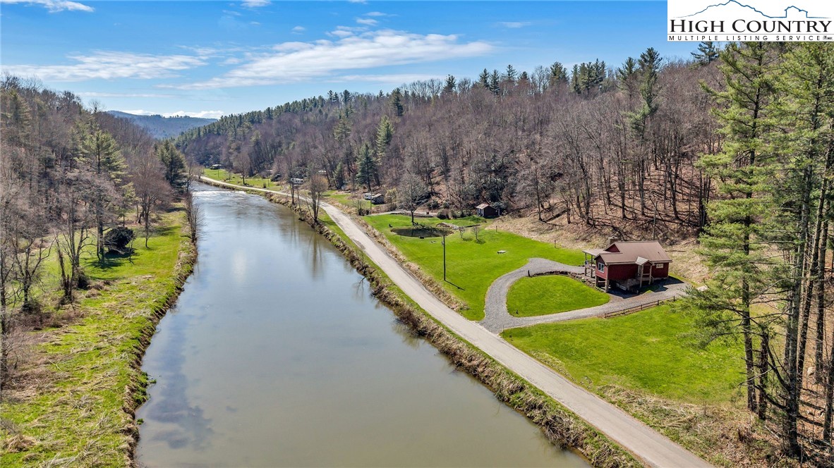 1976 Hartzog Ford Road West Jefferson, NC 28694 - Photo 3 of 50 a view of a house with a yard and lake view