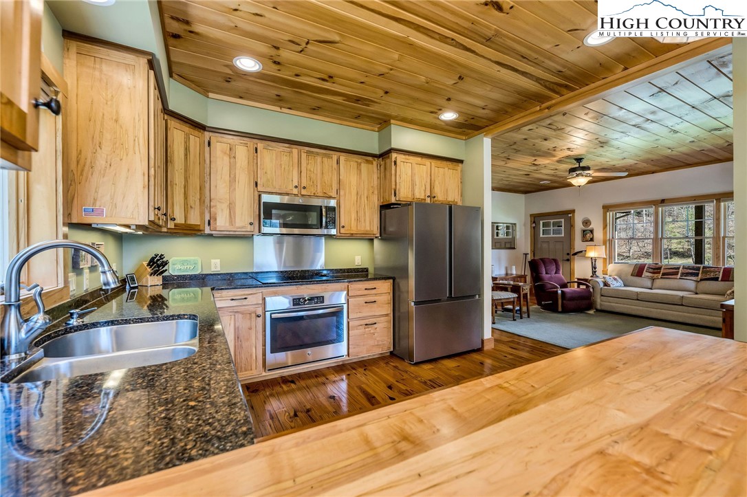 1976 Hartzog Ford Road West Jefferson, NC 28694 - Photo 33 of 50 a kitchen with a refrigerator and a sink