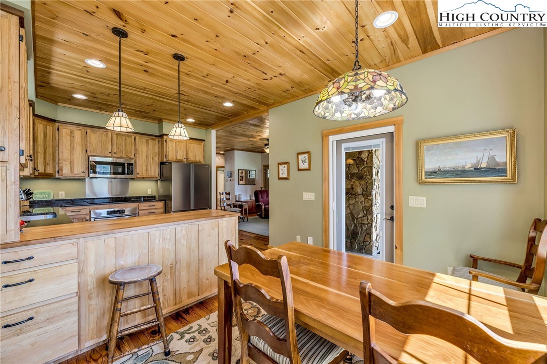 1976 Hartzog Ford Road West Jefferson, NC 28694 - Photo 35 of 50 a kitchen with stainless steel appliances kitchen island granite countertop a refrigerator and microwave
