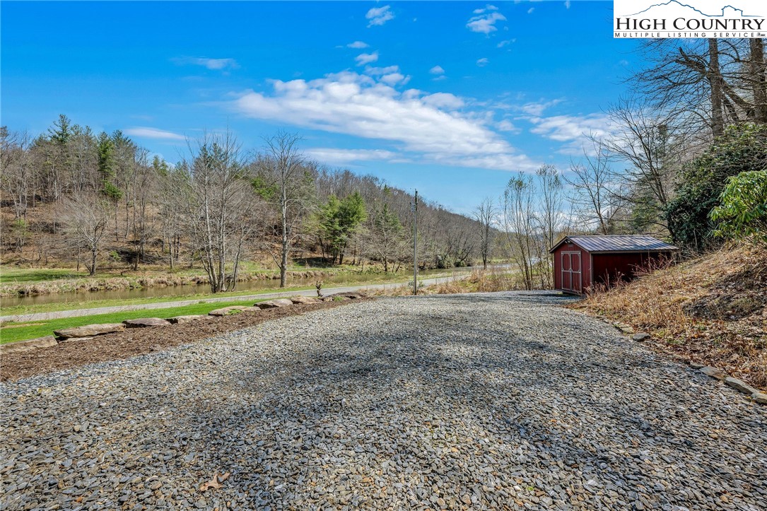 1976 Hartzog Ford Road West Jefferson, NC 28694 - Photo 41 of 50 a view of a yard with an trees