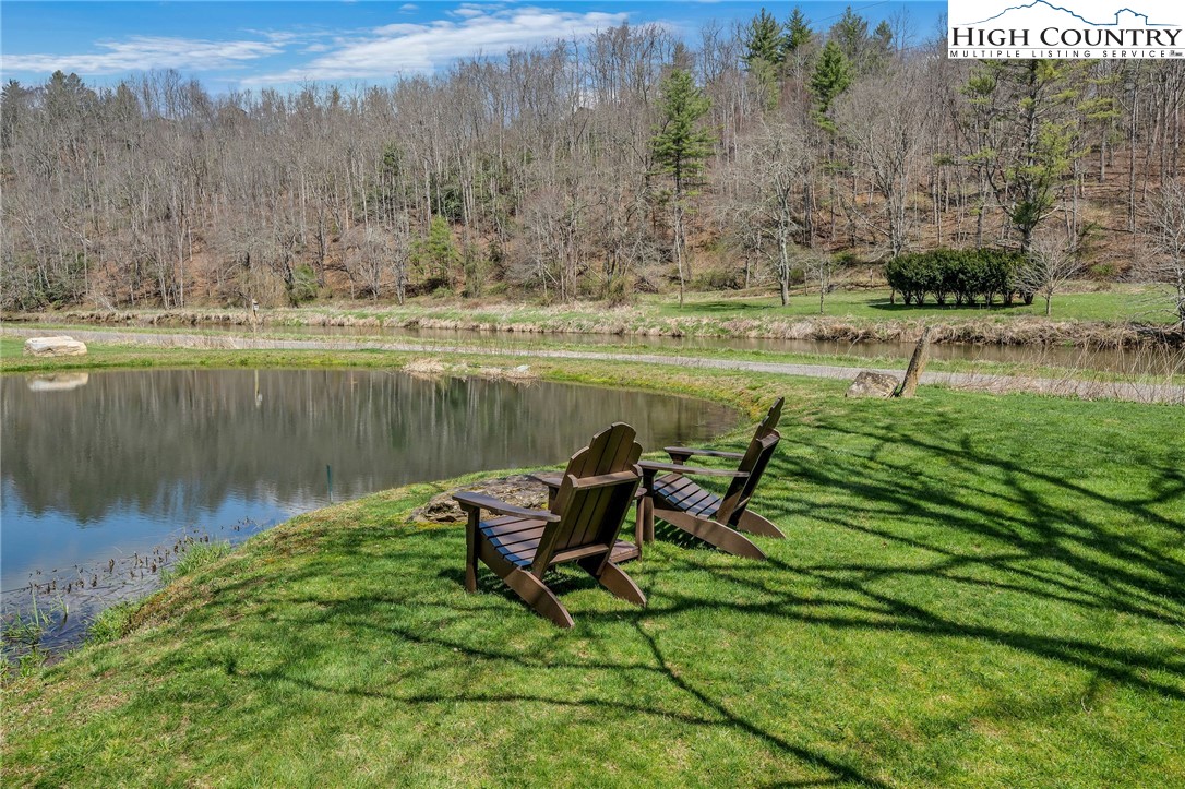 1976 Hartzog Ford Road West Jefferson, NC 28694 - Photo 42 of 50 a view of a lake with a yard