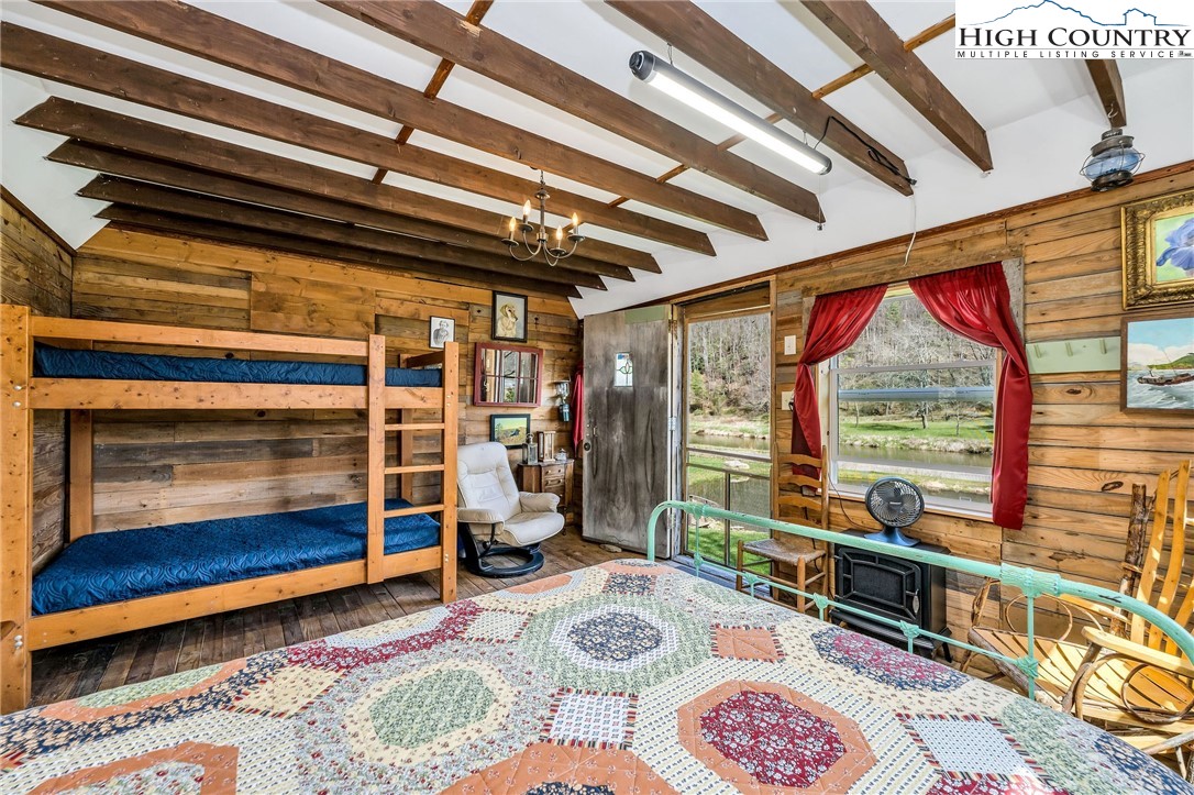 1976 Hartzog Ford Road West Jefferson, NC 28694 - Photo 43 of 50 a bedroom with furniture and a window