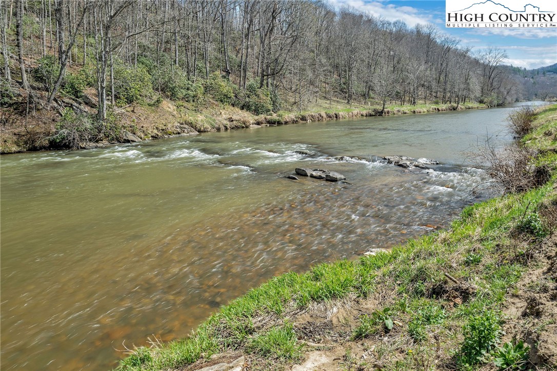 1976 Hartzog Ford Road West Jefferson, NC 28694 - Photo 49 of 50 a view of a lake with an outdoor space