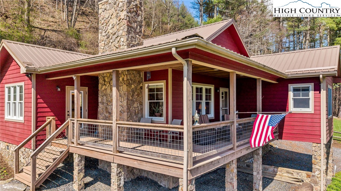 1976 Hartzog Ford Road West Jefferson, NC 28694 - Photo 7 of 50 a view of a house with a deck and furniture