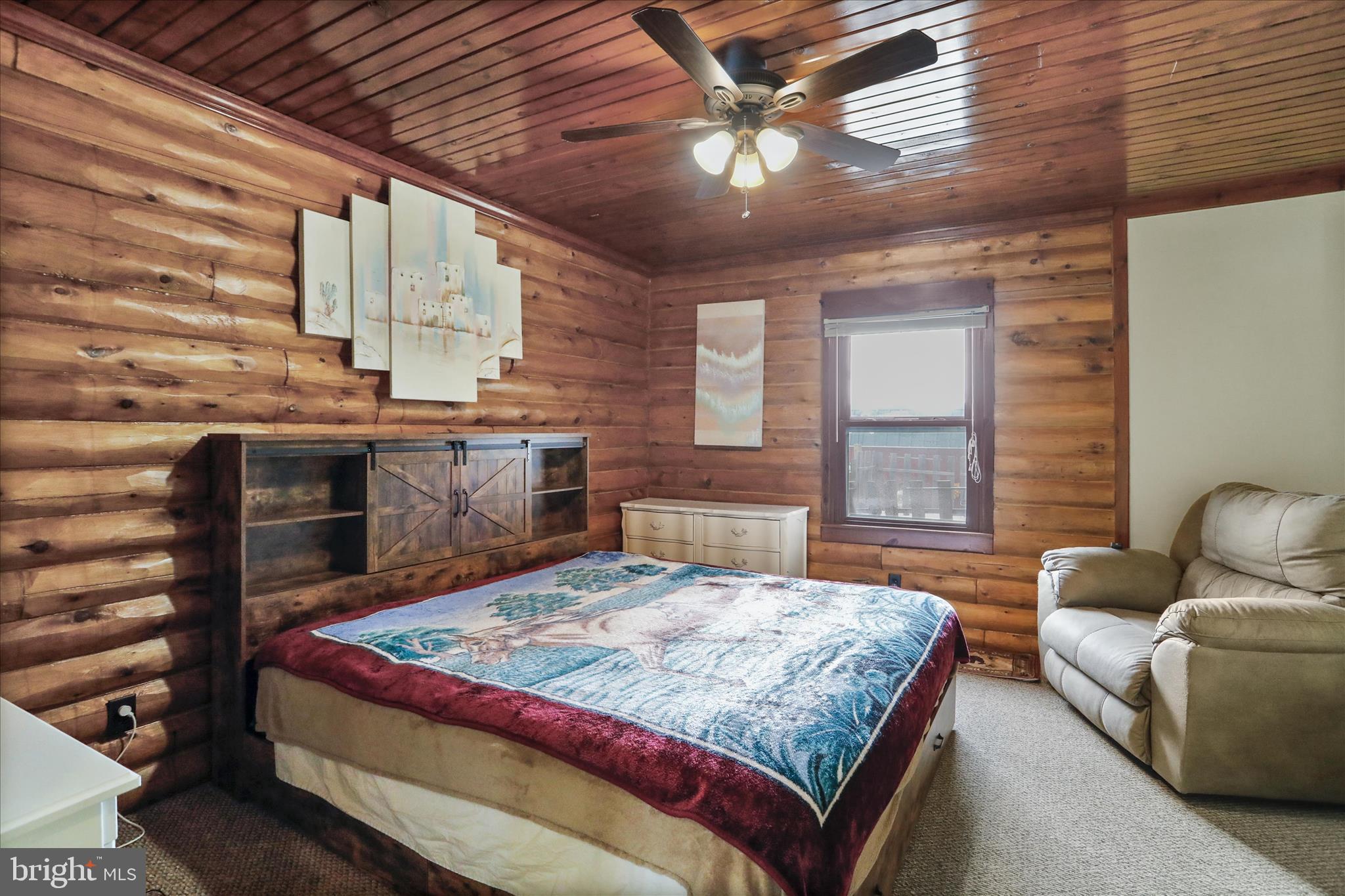 14507 Heavenly Acres Ridge Hancock, MD 21750 - Photo 28 of 70 a bedroom with a large bed and a chandelier