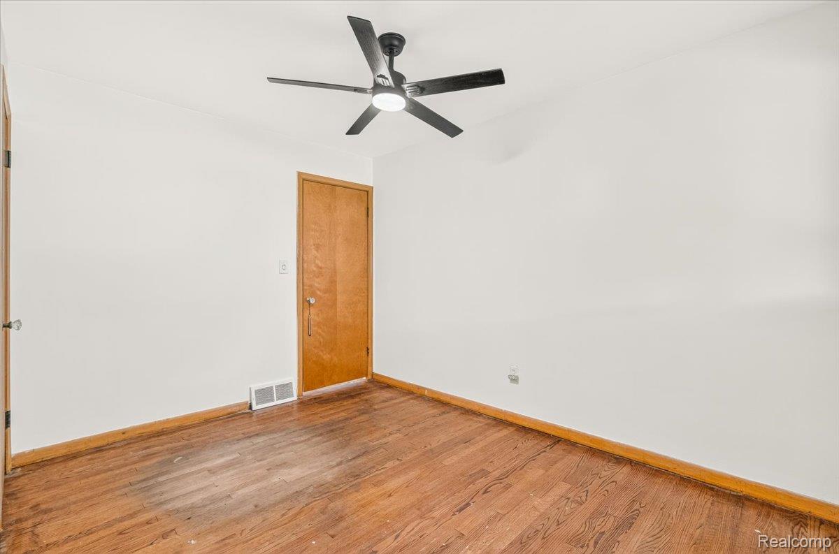 11802 Columbia Street Redford, MI 48239 - Photo 15 of 39 Bedroom 1 with Original Hardwood Floors in good condition, Vinyl Replacement Windows, and a New Ceiling Fan.