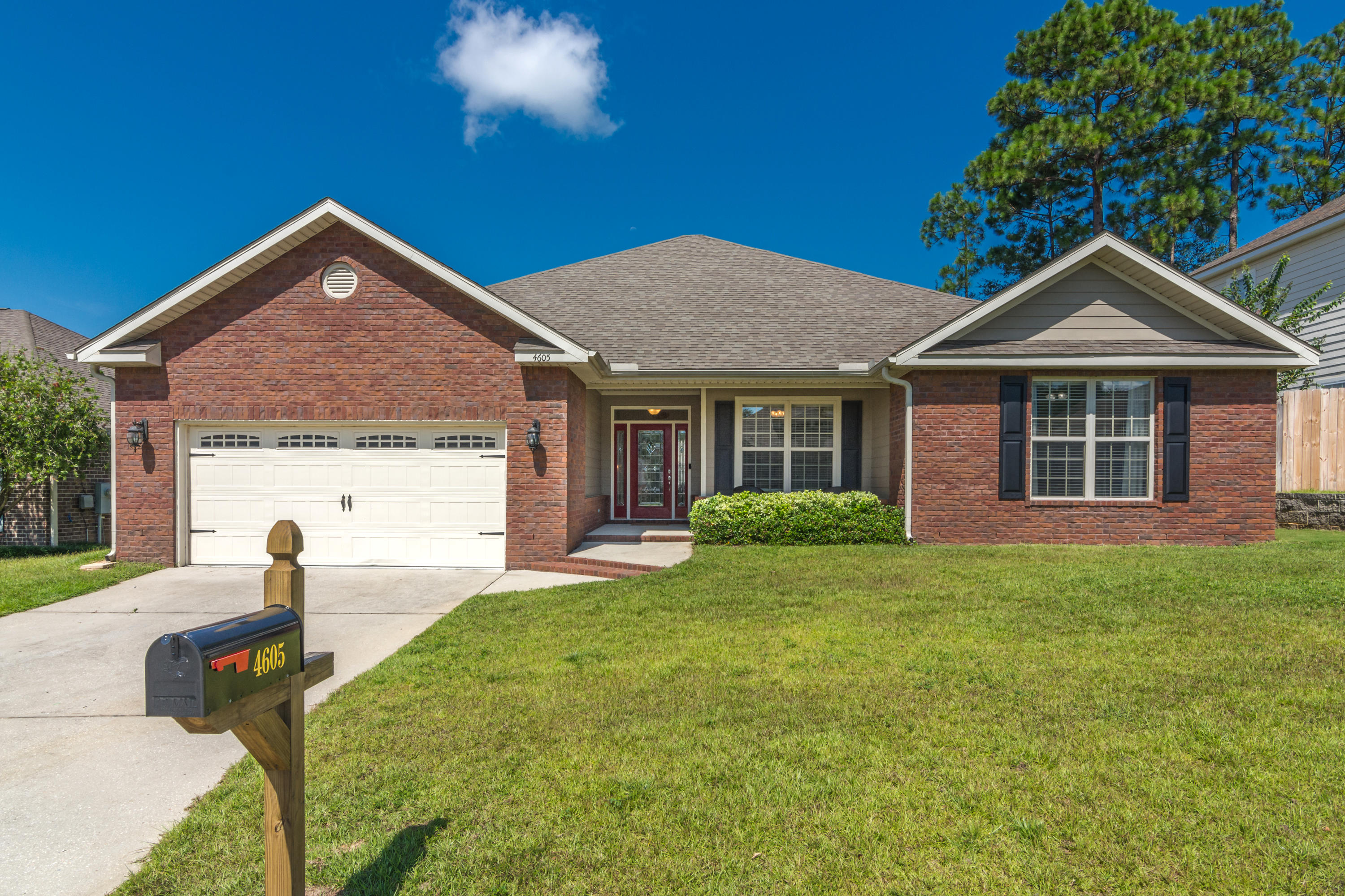 4605 Hermosa Road Crestview, FL 32539 - Photo 2 of 46 a view of a house with a yard and potted plants