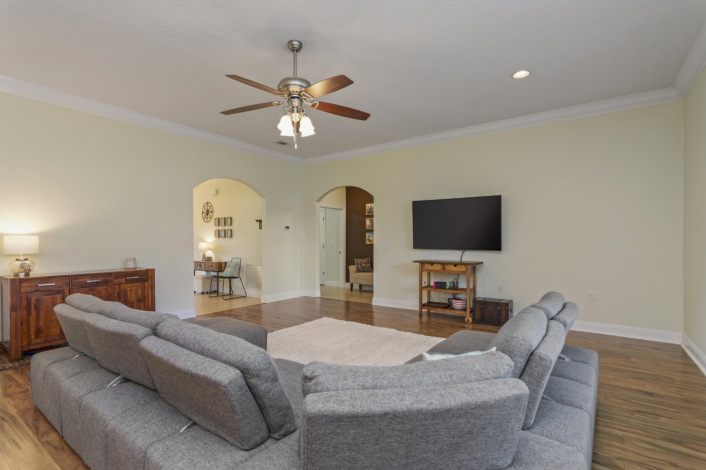 4605 Hermosa Road Crestview, FL 32539 - Photo 15 of 46 a living room with furniture a flat screen tv and a fireplace