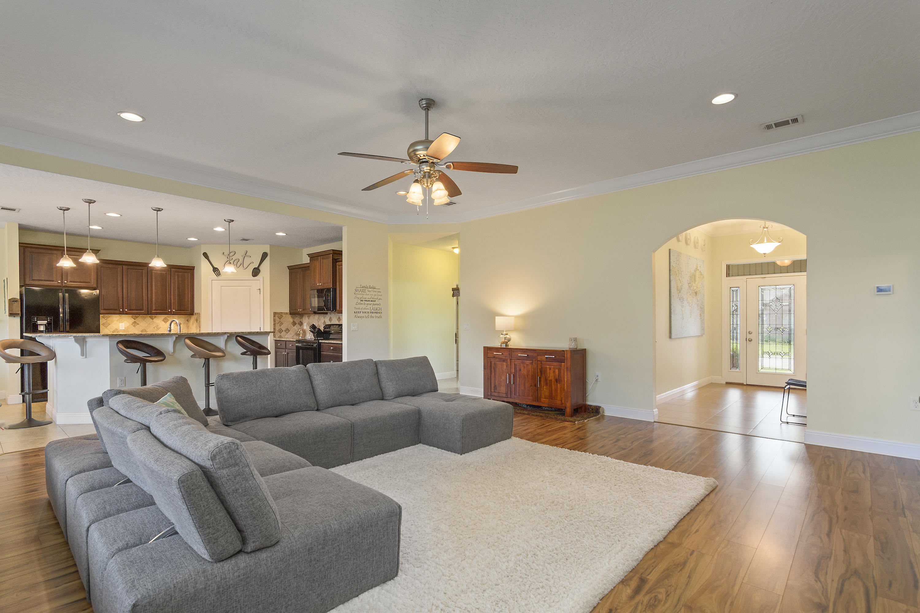 4605 Hermosa Road Crestview, FL 32539 - Photo 16 of 46 a living room with furniture and a chandelier