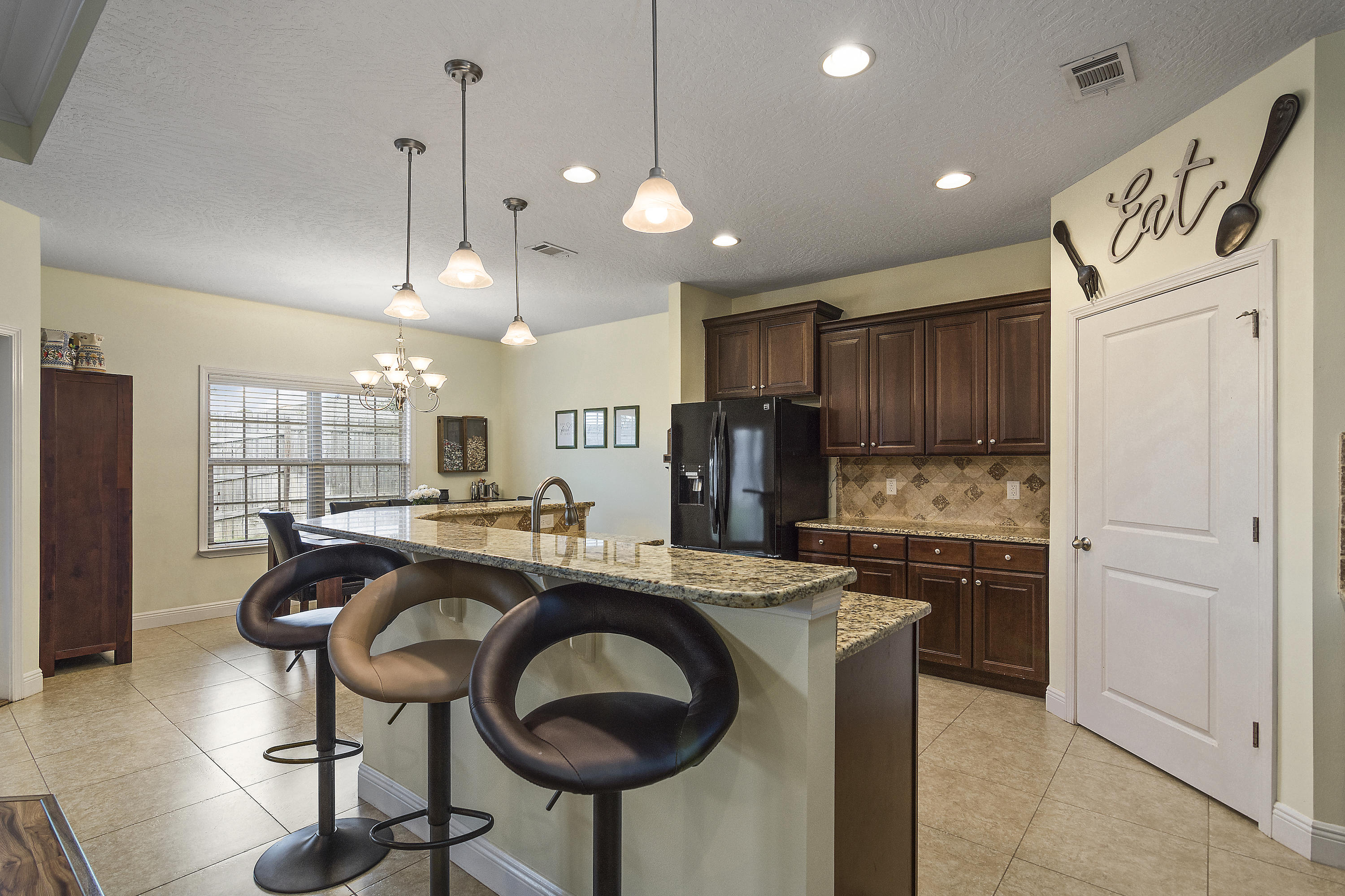 4605 Hermosa Road Crestview, FL 32539 - Photo 17 of 46 a kitchen with kitchen island a stove a refrigerator and a sink