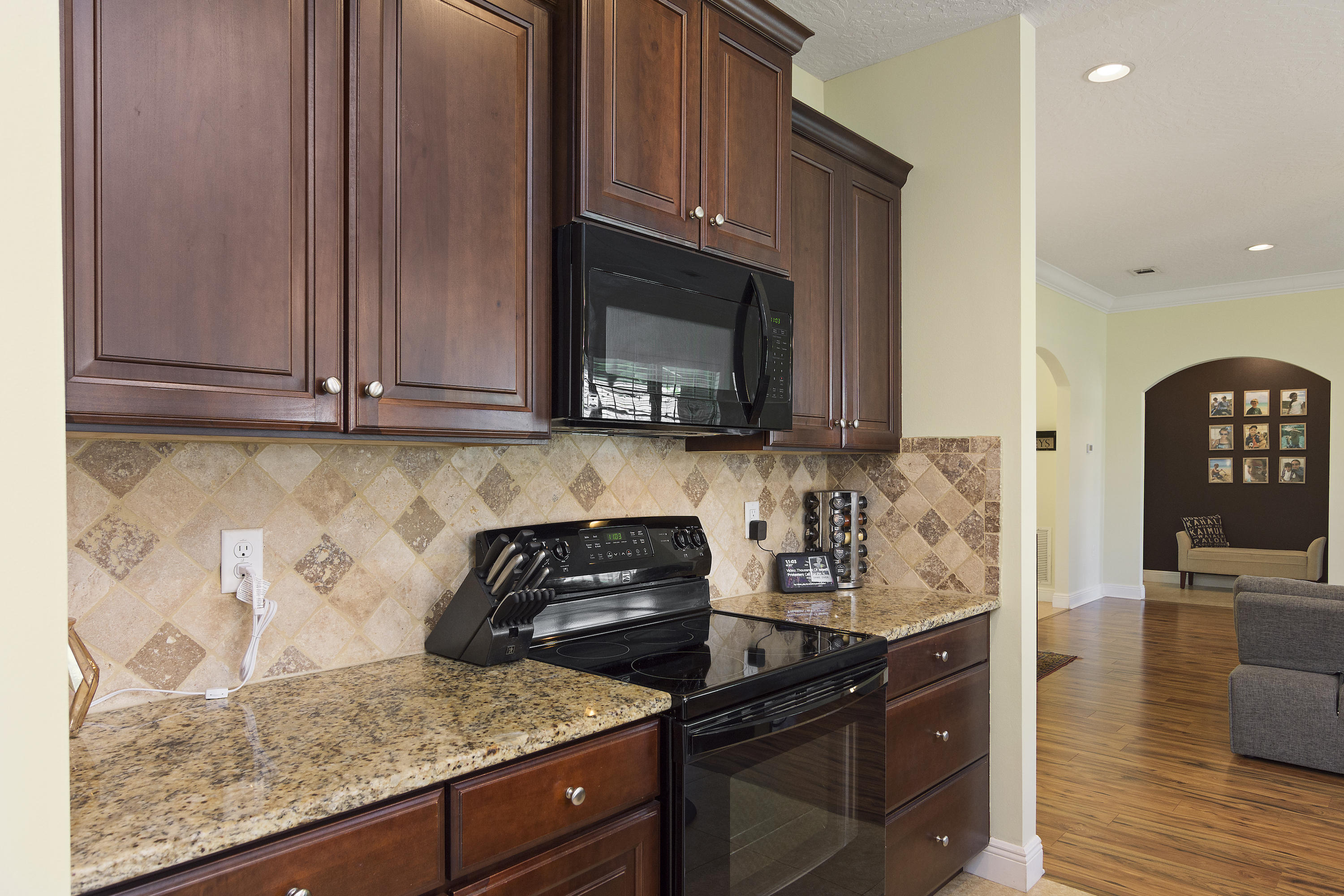 4605 Hermosa Road Crestview, FL 32539 - Photo 21 of 46 a kitchen with wooden cabinets and a stove top oven