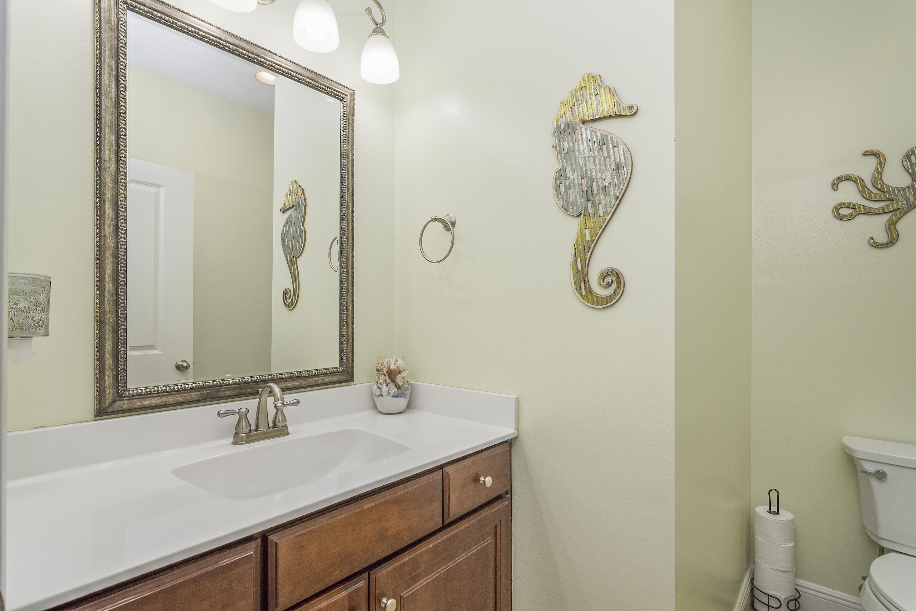 4605 Hermosa Road Crestview, FL 32539 - Photo 34 of 46 a bathroom with a granite countertop sink a toilet and a mirror